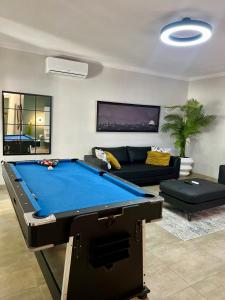 a living room with a pool table and a couch at 435 on vale boutique aparthotel in Johannesburg