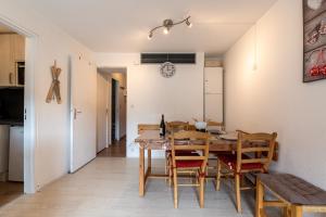 a kitchen and dining room with a table and chairs at Le Corbier - studio avec belle vue montagne in Villarembert +4 photos