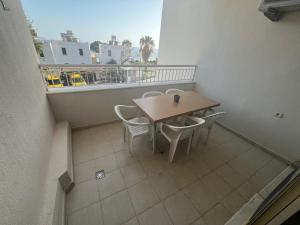 a balcony with a table and chairs on a balcony at HOLIDAY APART 50 meters to BEACH, Sea view apartments in Didim