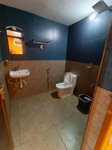 a bathroom with a toilet and a sink at Agronest Farm & Resort By Teal Luxury Stay in Wayanad