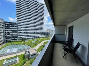 a balcony with a view of a large building at Spacious 1BR Apartment with Balcony above Citygate Shopping Complex with Metro Access in Vienna