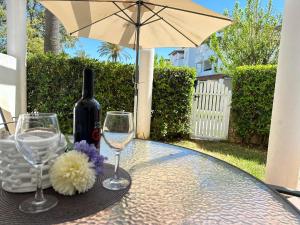 a table with a bottle of wine and two glasses at Taymar in Chiclana de la Frontera +208 photos