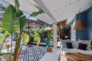 an outdoor patio with a couch and plants at Casa Bambou An hidden gem near Saint Tropez with private pool in Gassin