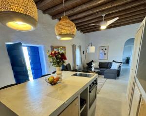 a kitchen with a counter with a bowl of fruit on it at Villa Kotseli - Sea View, Pool, Sunsets in Andros