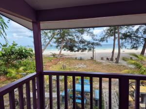 a balcony with a view of the beach at Chalet Ombak Rindu Kudat in Tiga Papan
