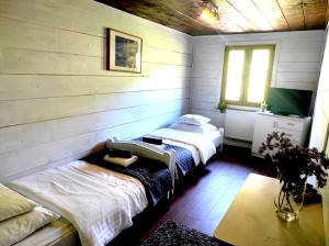 a room with two beds and a window in it at Pensjonat Laworta Ski in Ustrzyki Dolne