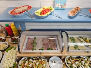 a buffet with dishes of food on a table at Harmony House in Świnoujście