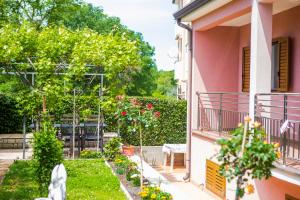 a balcony of a house with a garden at Apartments Lorena in Poreč