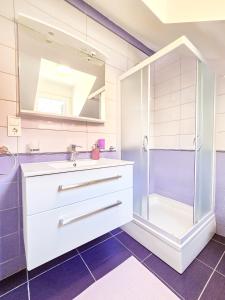 a bathroom with a sink and a shower at Stone House Varos Apartments in Split