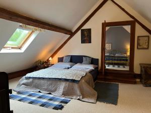 a bedroom with a bed and a large mirror at Forsthartl 7 Landhausurlaub in Steinbach