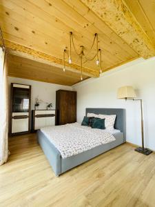 a bedroom with a bed and a wooden ceiling at Apartamenty u Ptaszka in Zakopane