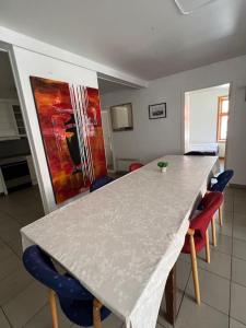 a kitchen with a counter with chairs and a table at Fishermans Apartment A13 in Nautnes +8 photos