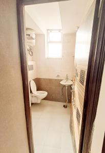 a bathroom with a toilet and a sink at Roomshala 160 Hotel Red - Vasant Kunj in New Delhi