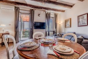 a dining room with a wooden table and chairs at Country Chic House in Castelnuovo di Porto