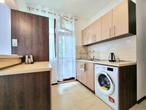 a kitchen with a washer and dryer in it at Comfortable Family Apartment with Parking in Burgas