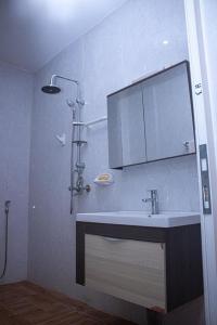 ein Bad mit einem Waschbecken und einem Spiegel in der Unterkunft Résidence GESAM in Sabalibougou