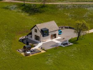 an aerial view of a small house in a field at Casera Cornolera in Chies dʼAlpago