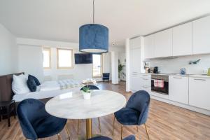 a kitchen and a living room with a table and chairs at Penthouse Panoramablick Whirlpool Parken in Koblenz