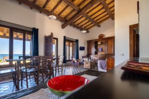 a kitchen and living room with a table and chairs at Casa sul Mare a Putzu Idu - Grazie di Esistere in Putzu Idu