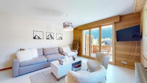 a living room with a couch and two chairs at Modern alpine apartment with sauna in Champéry