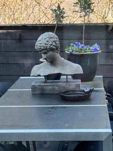 a statue of a child sitting on a table at Bed and Breakfast Lokaal Wadway in Spanbroek