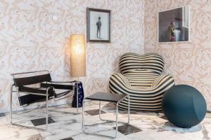 a living room with two chairs and a lamp at Solo Sokos Hotel Torni Helsinki in Helsinki