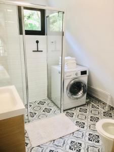 a bathroom with a washing machine in a shower at Rural Retreat Transylvania in Gura Rîului