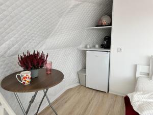 a small table in a room with a small refrigerator at Glamping 4 us in Topliţa