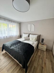 1 dormitorio con 1 cama grande con manta negra en Haus Ilmer, en Neustift im Stubaital