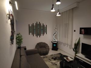 a living room with a couch and a tv at Dimitras apartment in Paleo Tsifliki +30 photos