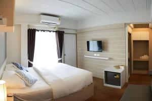 Postel nebo postele na pokoji v ubytování Prix Hotel