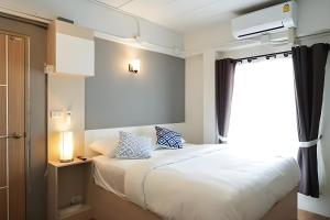Postel nebo postele na pokoji v ubytování Prix Hotel