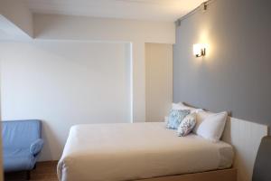 Postel nebo postele na pokoji v ubytování Prix Hotel