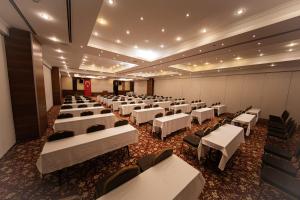 a banquet hall with white tables and chairs at Rox Resort Hotel in Kemer +70 photos
