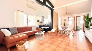 a living room with a couch and a table at Oasis Beach Holiday Home with jacuzzi in Playa del Ingles