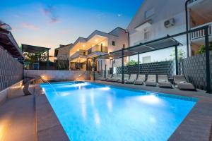 a swimming pool in the backyard of a house at Villa Maria in Podglavica