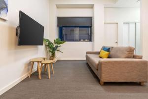 a living room with a couch and a table at Terminus Apartment Hotel, Ascend Hotel Collection in Newcastle
