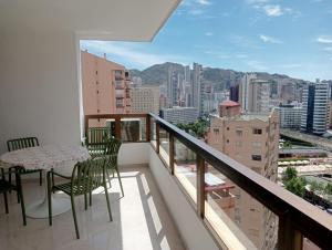 a balcony with a table and chairs and a view at Apartamentos Gemelos 2 y 4 by Gestaltur in Benidorm