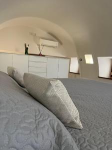 a bedroom with a bed with pillows on it at Casa Pont1 Historic Pontone near Amalfi & Ravello in Scala