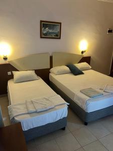 Postel nebo postele na pokoji v ubytování Best Hotel