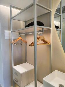 a walk in closet with a mirror and a sink at Valentin Somni Hotel & Suites in Paguera