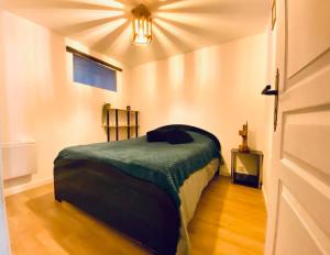 a bedroom with a bed in a room with a ceiling at Joli Appartement Proche Plage in Ahetze