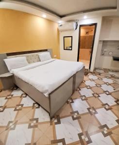 a large bed in a room with a tiled floor at Hotel Red - Vasant Kunj in New Delhi