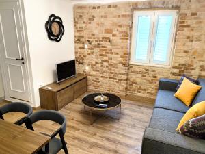 a living room with a couch and a tv at Casa Contessina in Corfu Town