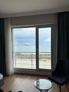 ein Wohnzimmer mit einem großen Fenster mit Meerblick in der Unterkunft Orient Hotel in Van