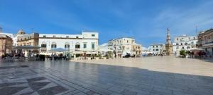 a city square with a group of white buildings at Vico Anglani Guest House in Ostuni