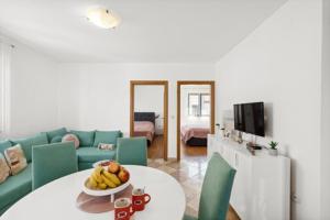 salon ze stołem i miską owoców w obiekcie Apartmani Lorena w Poreču