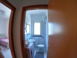 a bathroom with a toilet and a sink at Maison Carmela in Monopoli +4 photos