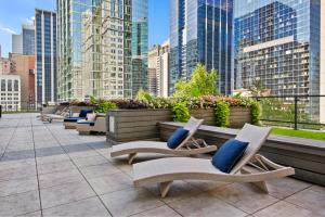 een rij stoelen op een balkon met gebouwen bij Loop Studio w Pool Gym Lounge nr Riverwalk CHI-633 in Chicago