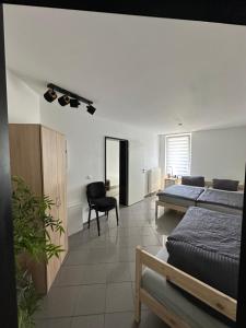 a bedroom with a bed and a desk and a chair at Ferienwohnung Sindorf in Kerpen